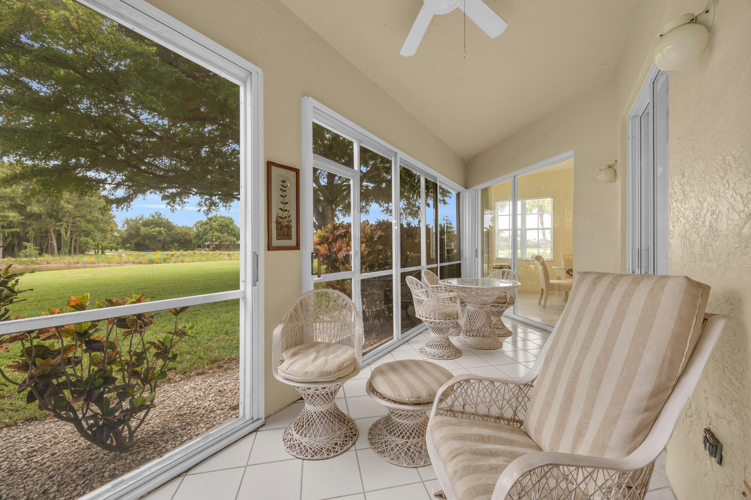 10172 Andover Coach Circle, Unit G2 Lake Worth, FL 33449 - Photo 33 of 64 a living room with furniture and a floor to ceiling window