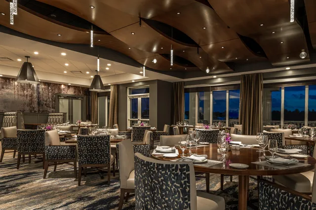 a room with a table chairs and a workspace