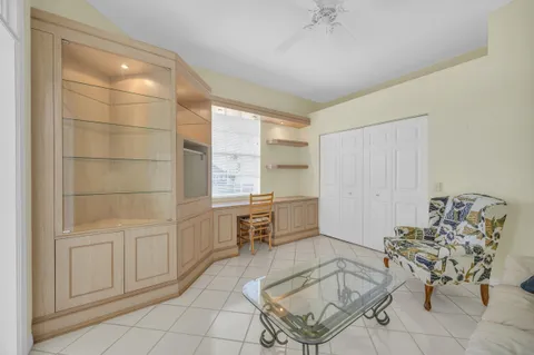 a living room with furniture and a painting on the wall