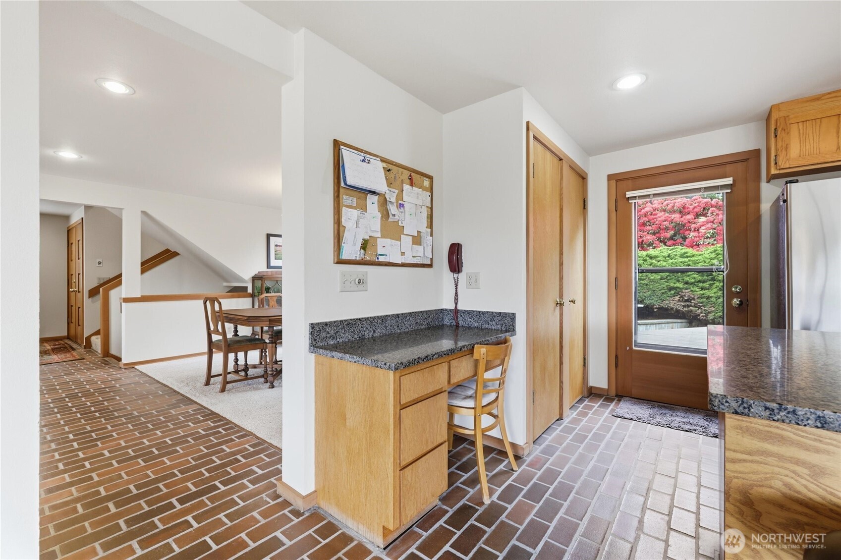 9520 Odin Way Bothell, WA 98011 - Photo 12 of 40 a kitchen with granite countertop dining table chairs and a potted plant