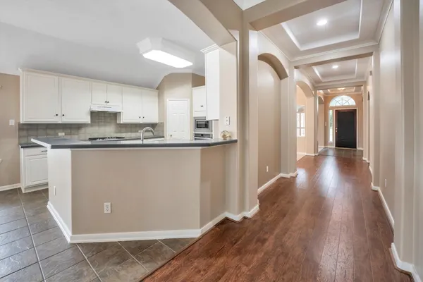 a view of a big room with windows and chandelier