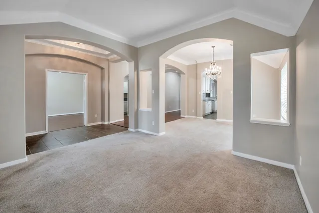 an empty room with windows and mirror