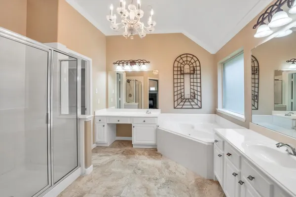 a bathroom with a sink a large mirror and a bathtub