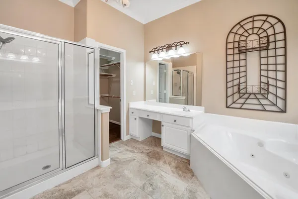 a bathroom with a sink a large mirror and a bathtub