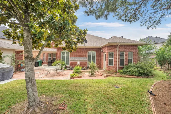 a view of a house with backyard porch and sitting area