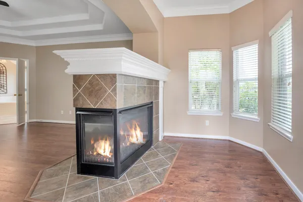 wooden floor in an empty room with a fireplace