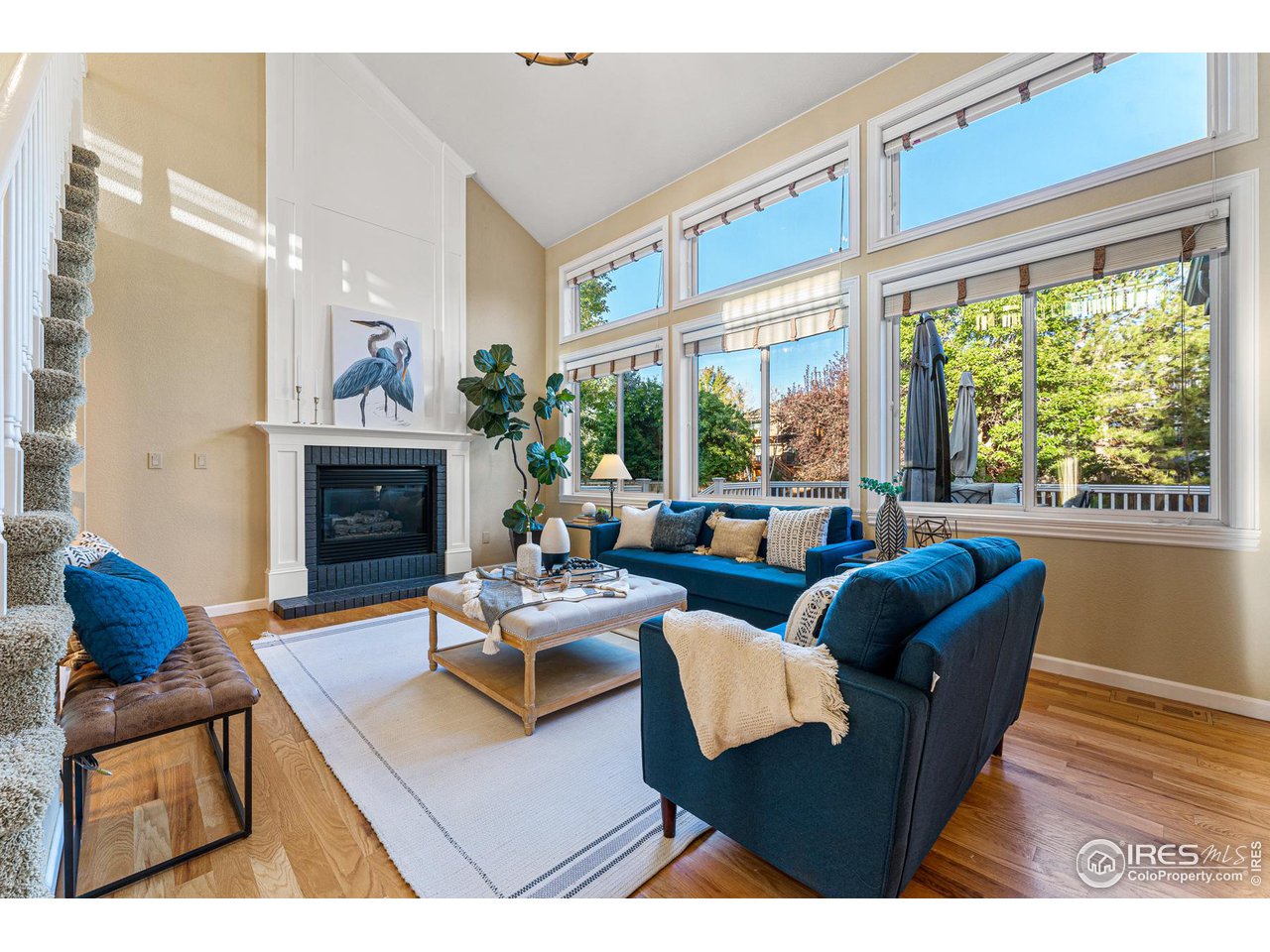 7452 Augusta Drive Boulder, CO 80301 - Photo 11 of 40 a living room with furniture a fireplace and a large window