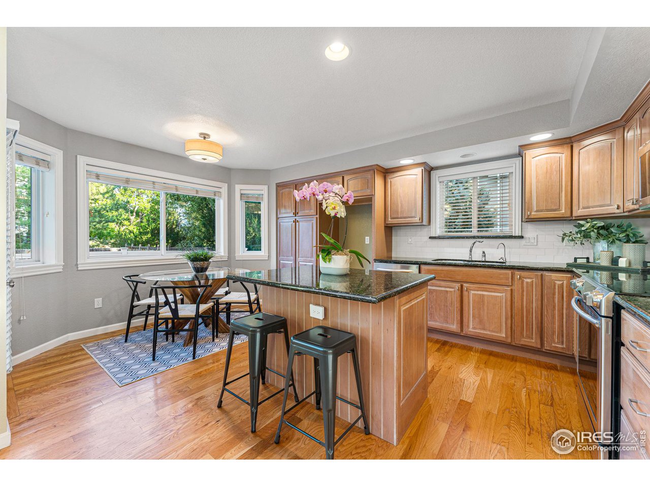 7452 Augusta Drive Boulder, CO 80301 - Photo 14 of 40 a kitchen with a table chairs and wooden floor