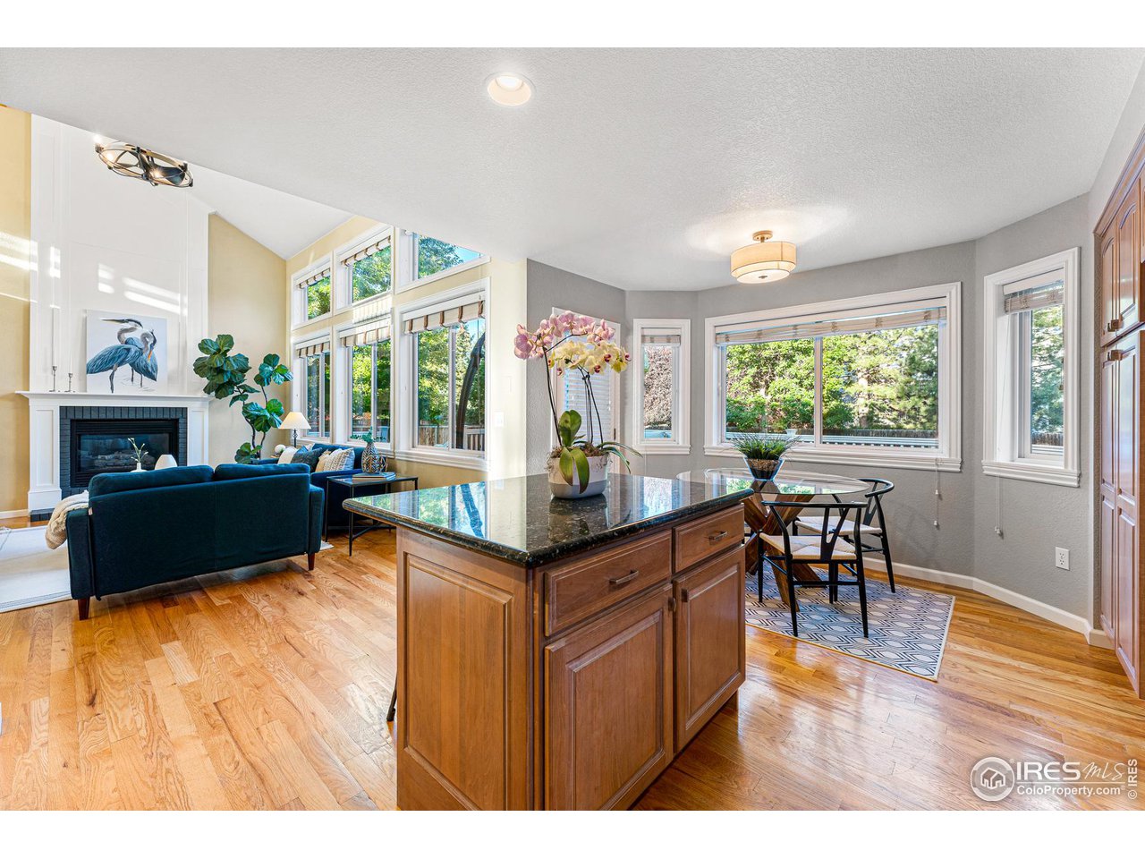 7452 Augusta Drive Boulder, CO 80301 - Photo 16 of 40 a kitchen with granite countertop a stove a sink a dining table and chairs