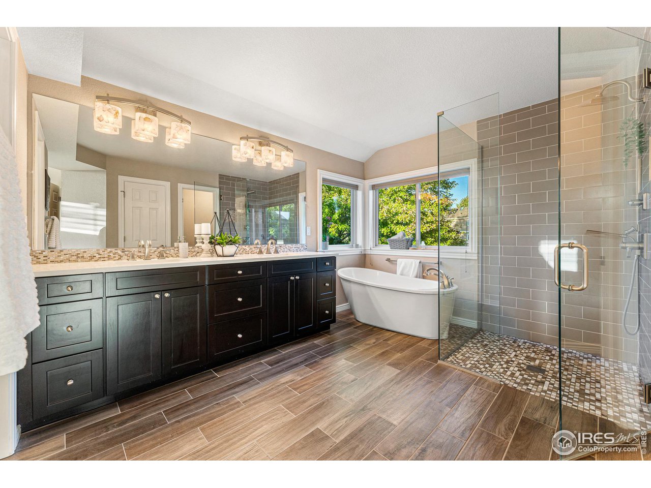 7452 Augusta Drive Boulder, CO 80301 - Photo 25 of 40 a bathroom with a double vanity sink a mirror and a shower