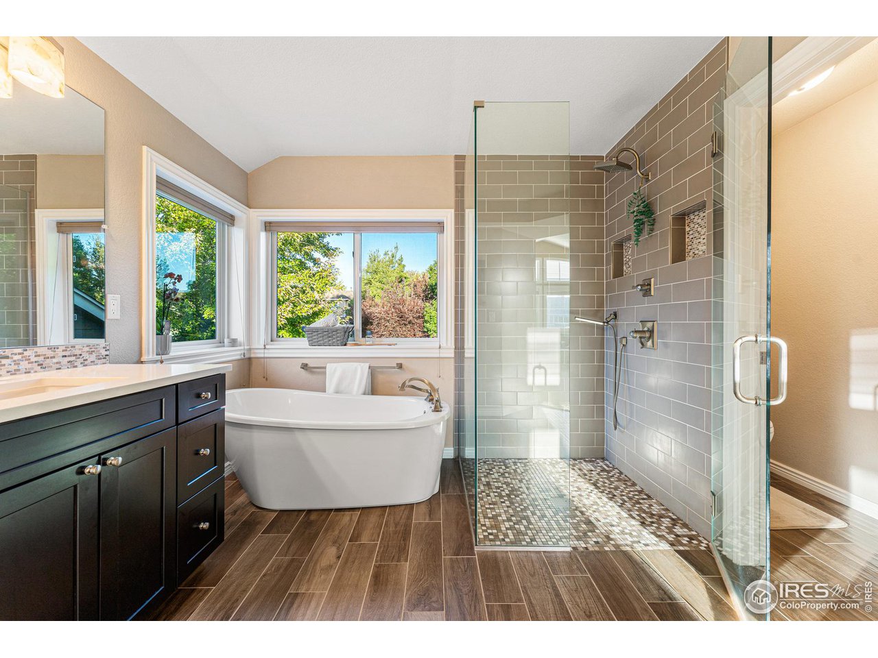 7452 Augusta Drive Boulder, CO 80301 - Photo 26 of 40 a bathroom with a sink a toilet a large mirror and shower