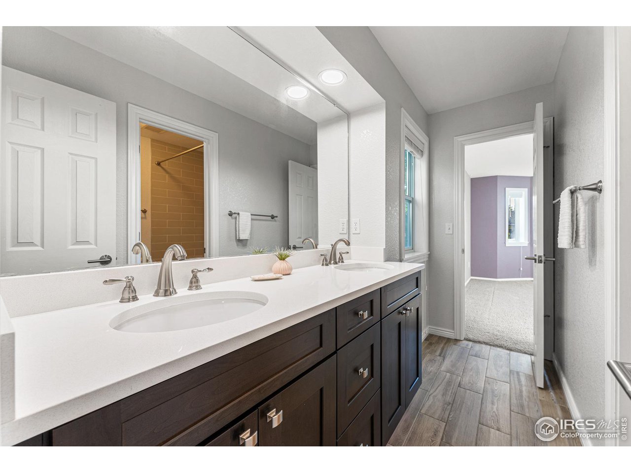 7452 Augusta Drive Boulder, CO 80301 - Photo 29 of 40 a bathroom with a sink a mirror and a shower