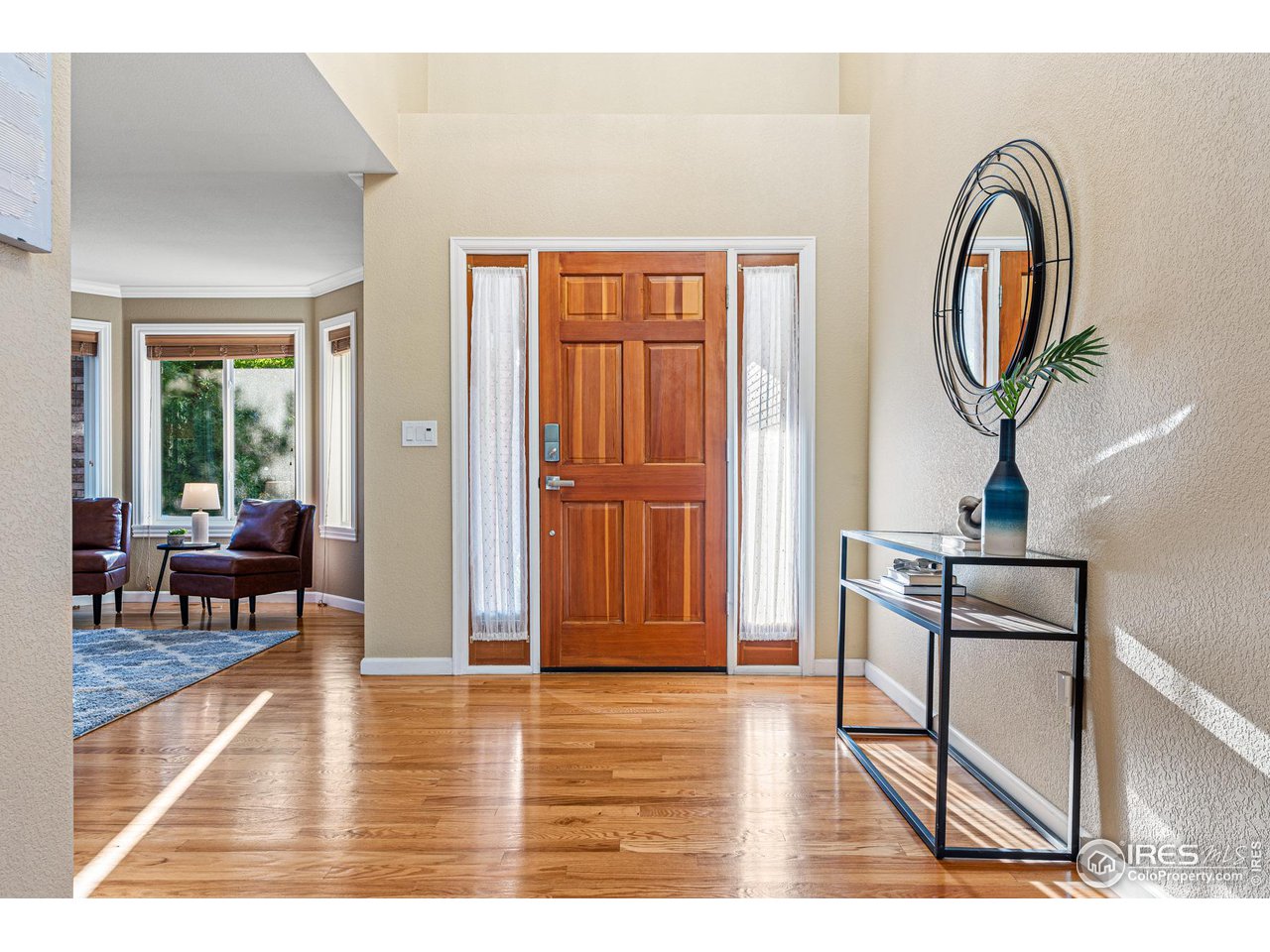 7452 Augusta Drive Boulder, CO 80301 - Photo 3 of 40 a view of a livingroom kitchen and hall with wooden floor