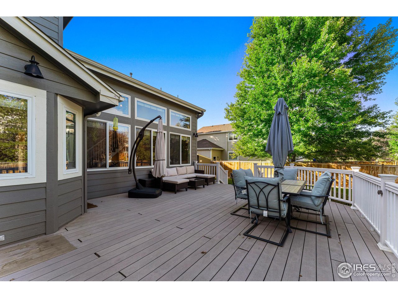 7452 Augusta Drive Boulder, CO 80301 - Photo 34 of 40 a view of a patio with table and chairs and wooden floor