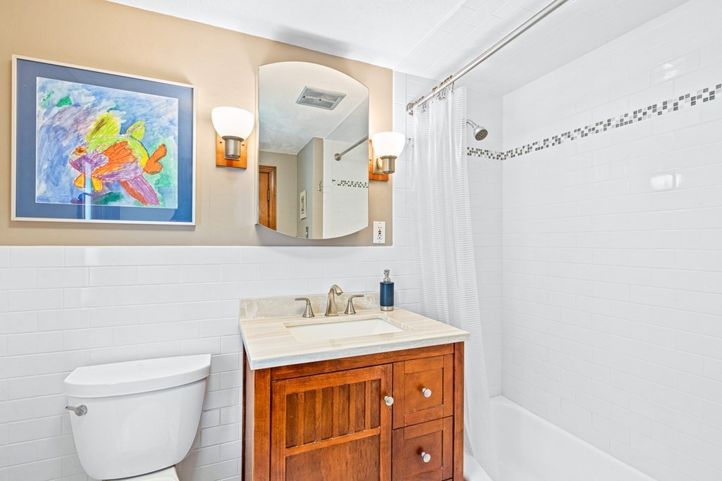 11 Ronald Road Arlington, MA 02474 - Photo 18 of 42 a bathroom with a sink a vanity and a mirror