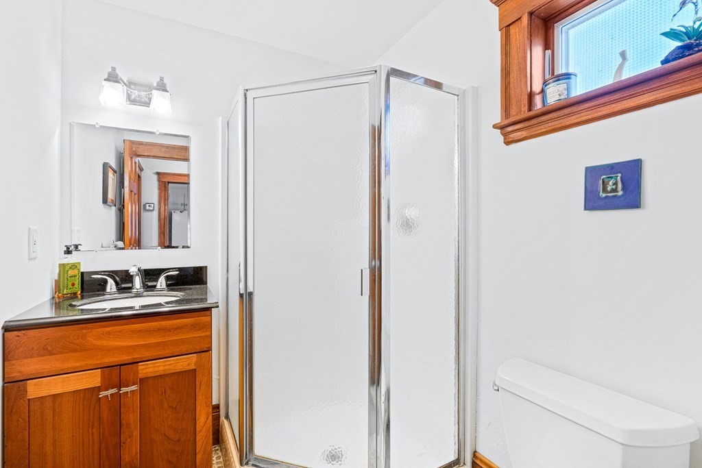 11 Ronald Road Arlington, MA 02474 - Photo 23 of 42 a bathroom with a sink a mirror and a shower