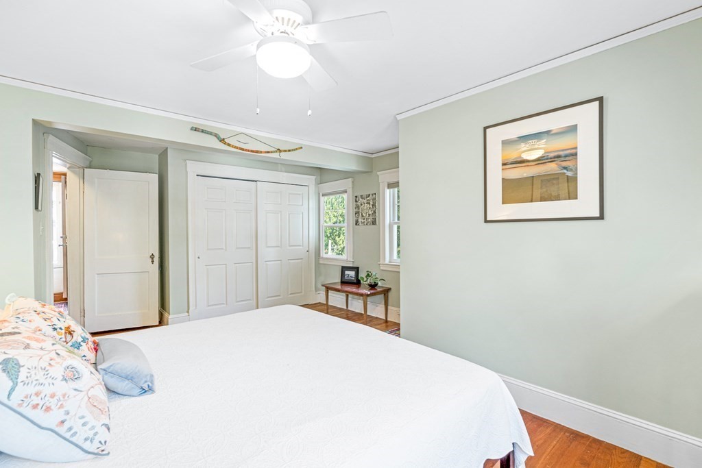 11 Ronald Road Arlington, MA 02474 - Photo 25 of 42 a bedroom with a large bed and a chandelier