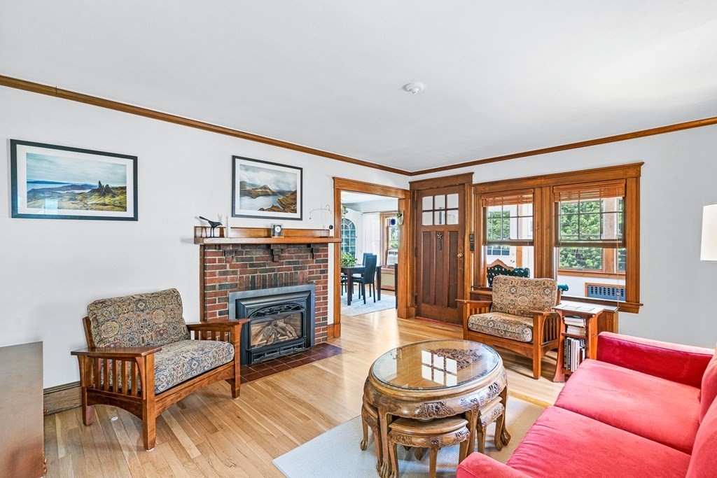 11 Ronald Road Arlington, MA 02474 - Photo 8 of 42 a living room with furniture a fireplace and a large window