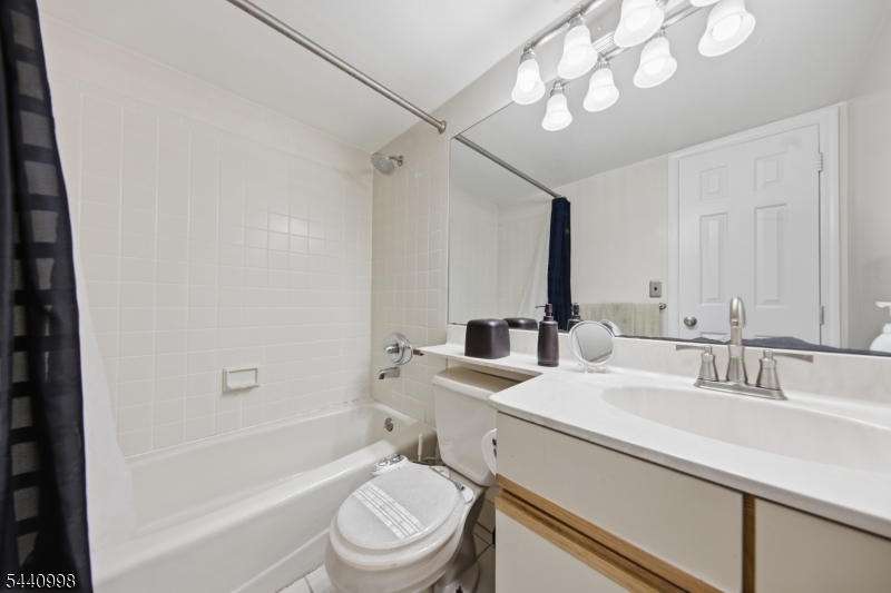 609 Mark Twain Way Mahwah, NJ 07430 - Photo 16 of 40 a bathroom with a sink a toilet and shower
