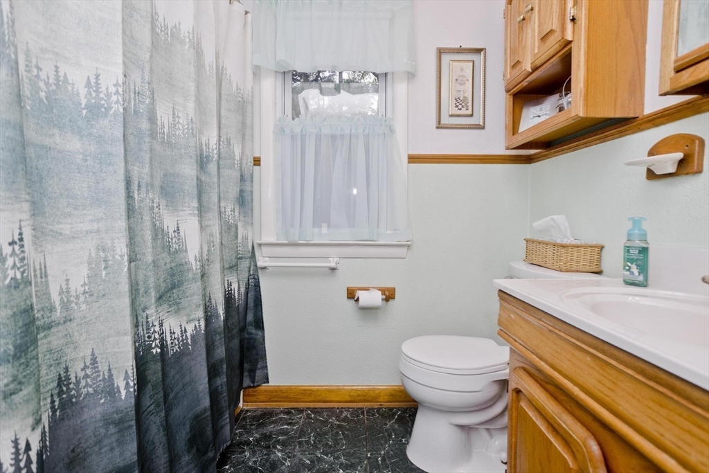 6 North Brook Road Springfield, MA 01119 - Photo 25 of 42 a bathroom with a toilet and a shower curtain