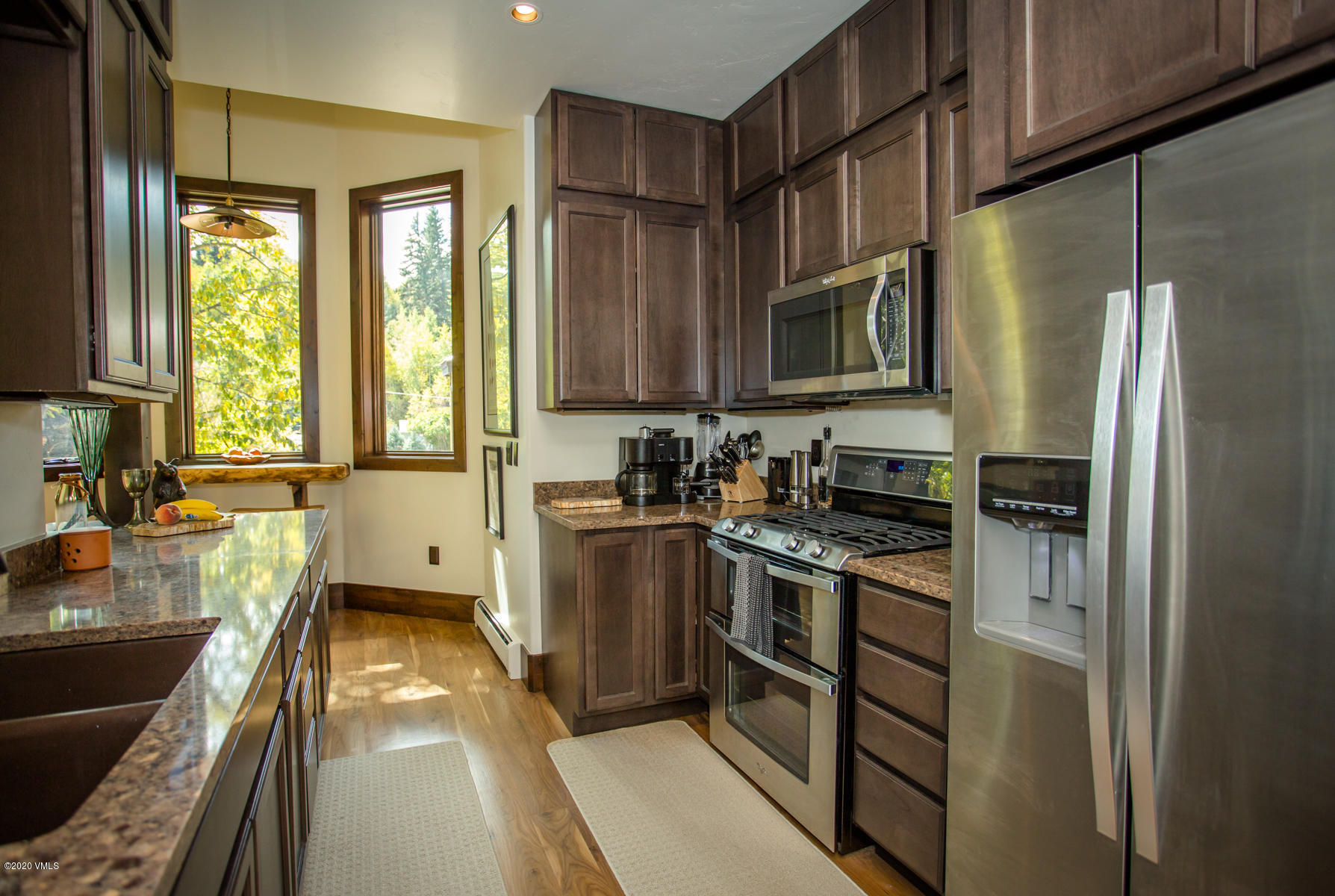 850 Main Street, Unit A Minturn, CO 81645 - Photo 12 of 34 a kitchen with stainless steel appliances granite countertop a stove a sink and a refrigerator