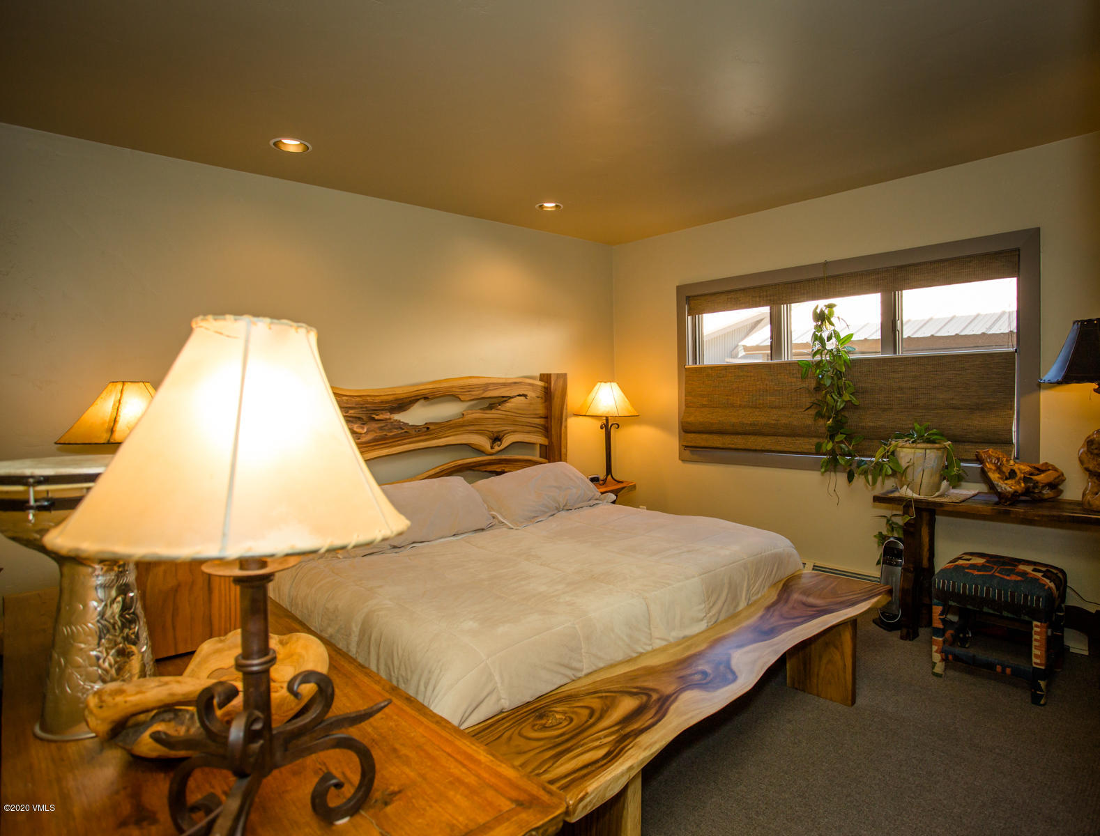 850 Main Street, Unit A Minturn, CO 81645 - Photo 27 of 34 a bedroom with a bed and lamp next to a window
