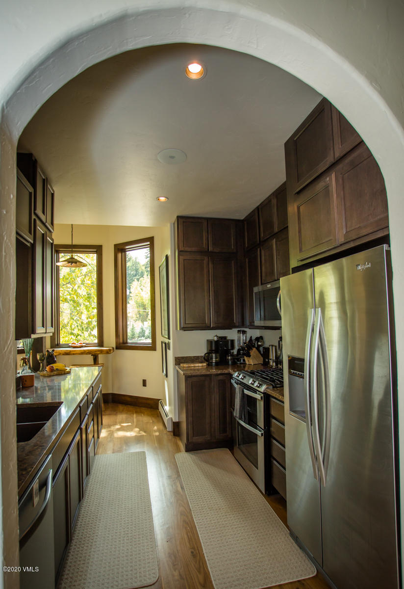 850 Main Street, Unit A Minturn, CO 81645 - Photo 5 of 34 a kitchen with stainless steel appliances a refrigerator stove and sink