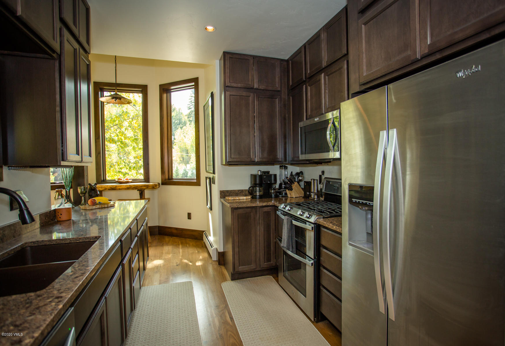 850 Main Street, Unit A Minturn, CO 81645 - Photo 8 of 34 a kitchen with stainless steel appliances granite countertop a refrigerator a sink a stove and cabinets