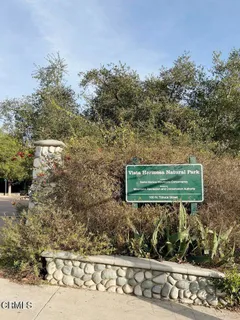a view of a green field with some trees