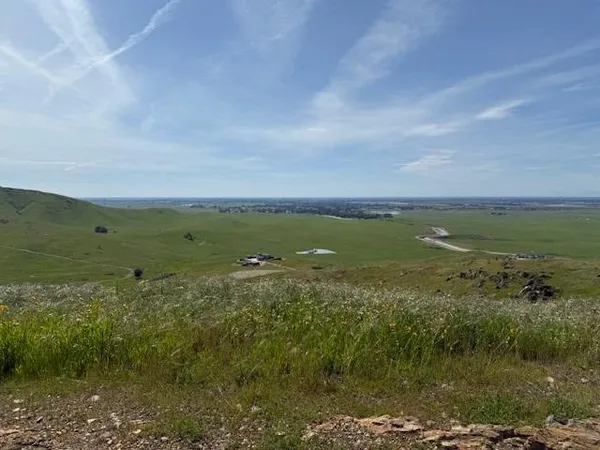 a view of a field with an ocean view