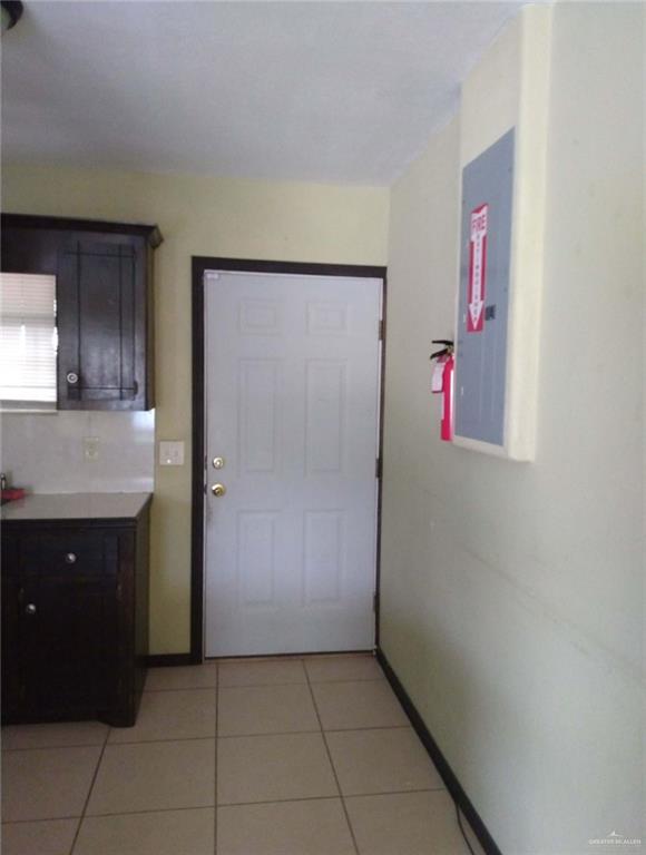 5497 East Guerra Street Rio Grande City, TX 78582 - Photo 11 of 13 a kitchen with granite countertop cabinets and refrigerator