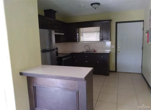a kitchen with a sink stove and refrigerator
