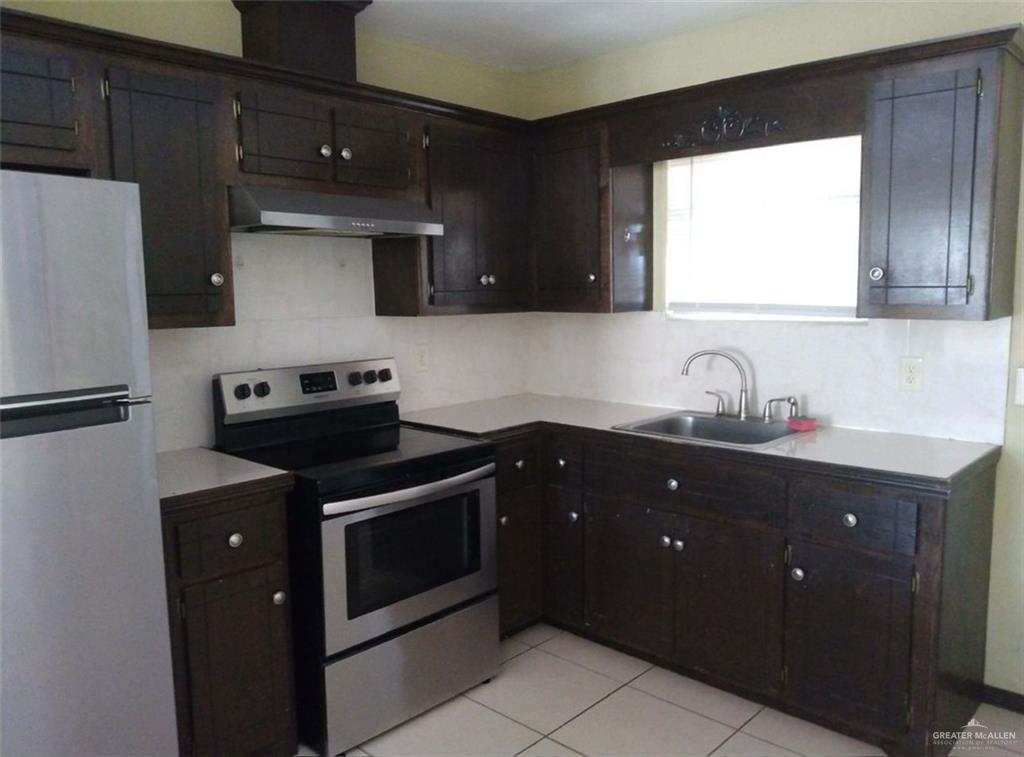 5497 East Guerra Street Rio Grande City, TX 78582 - Photo 5 of 13 a kitchen with a sink stove and refrigerator