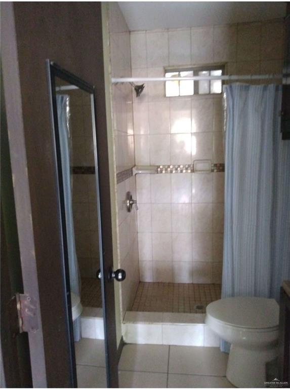 5497 East Guerra Street Rio Grande City, TX 78582 - Photo 8 of 13 a bathroom with a shower and a toilet