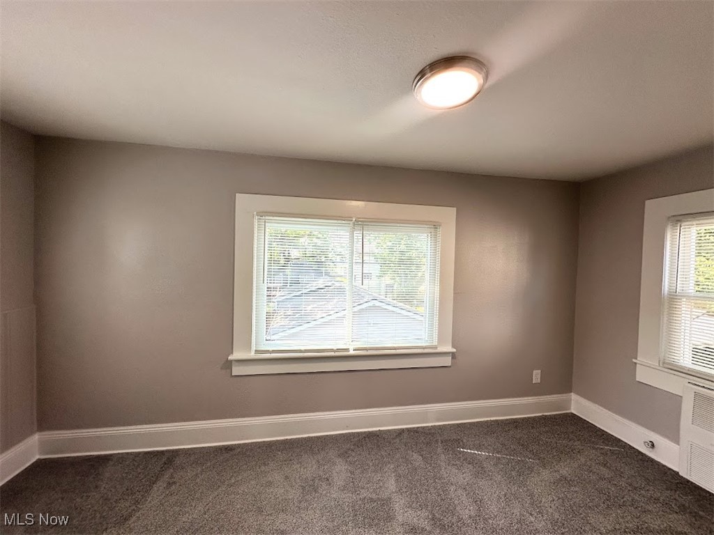 3288 Kildare Road Cleveland, OH 44118 - Photo 13 of 18 Empty room featuring dark colored carpet and baseboards