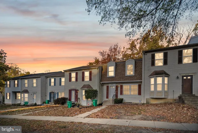 a front view of a residential apartment building with a yard