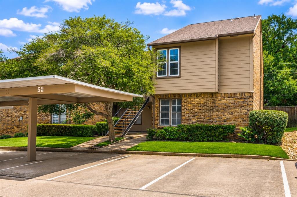 Front view of upstairs end unit with carport, cars removed from photo with AI.