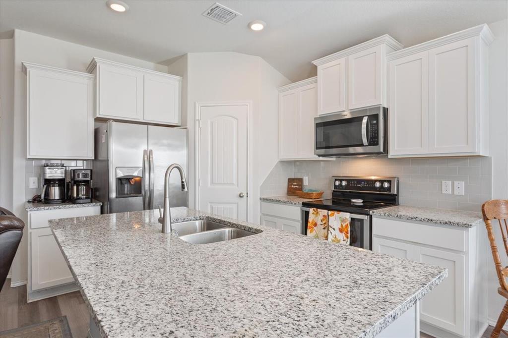11204 Echo Drive Waco, TX 76708 - Photo 13 of 27 a kitchen with stainless steel appliances wooden cabinets and granite counter tops