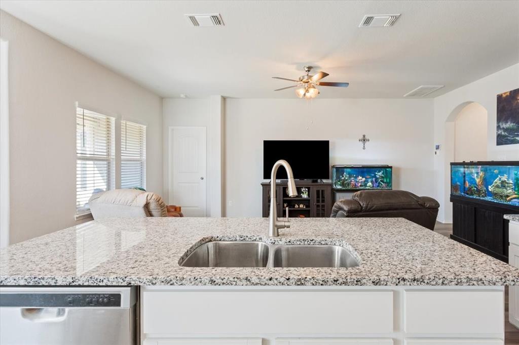11204 Echo Drive Waco, TX 76708 - Photo 14 of 27 a kitchen with kitchen island granite countertop a sink a counter top space and living room view