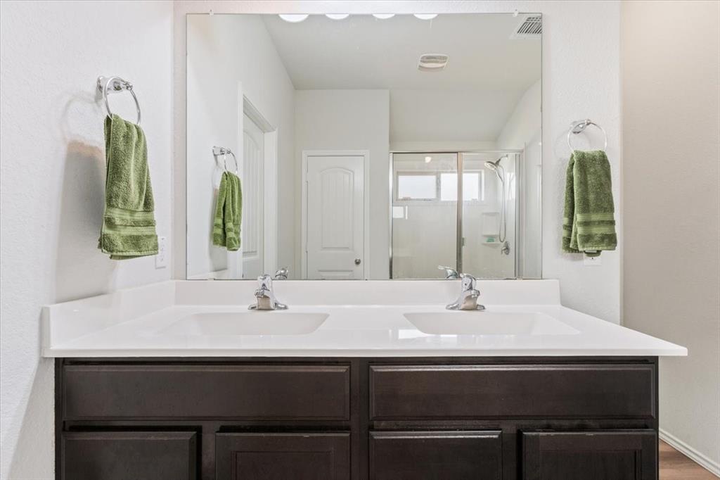 11204 Echo Drive Waco, TX 76708 - Photo 18 of 27 a sink with a mirror and a window