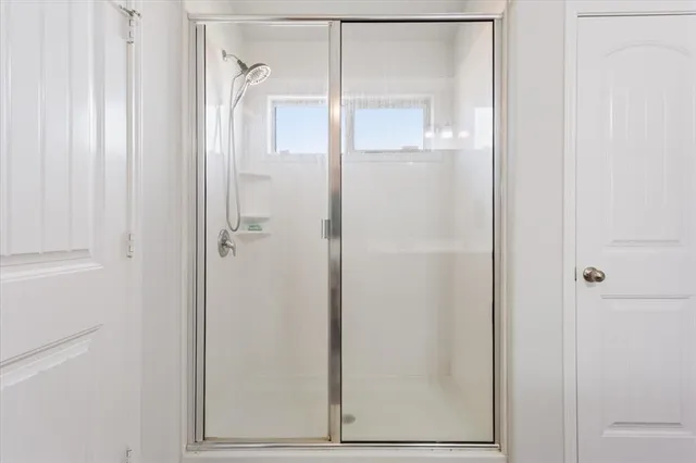 a bathroom with a glass shower door