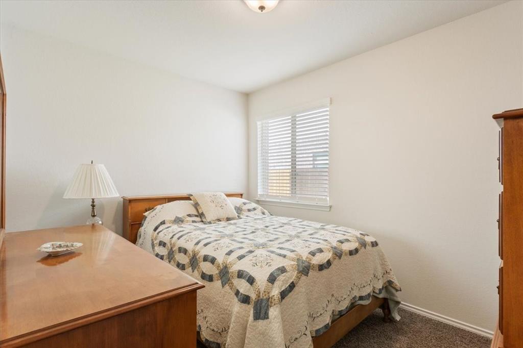 11204 Echo Drive Waco, TX 76708 - Photo 20 of 27 a bedroom with a bed and a window