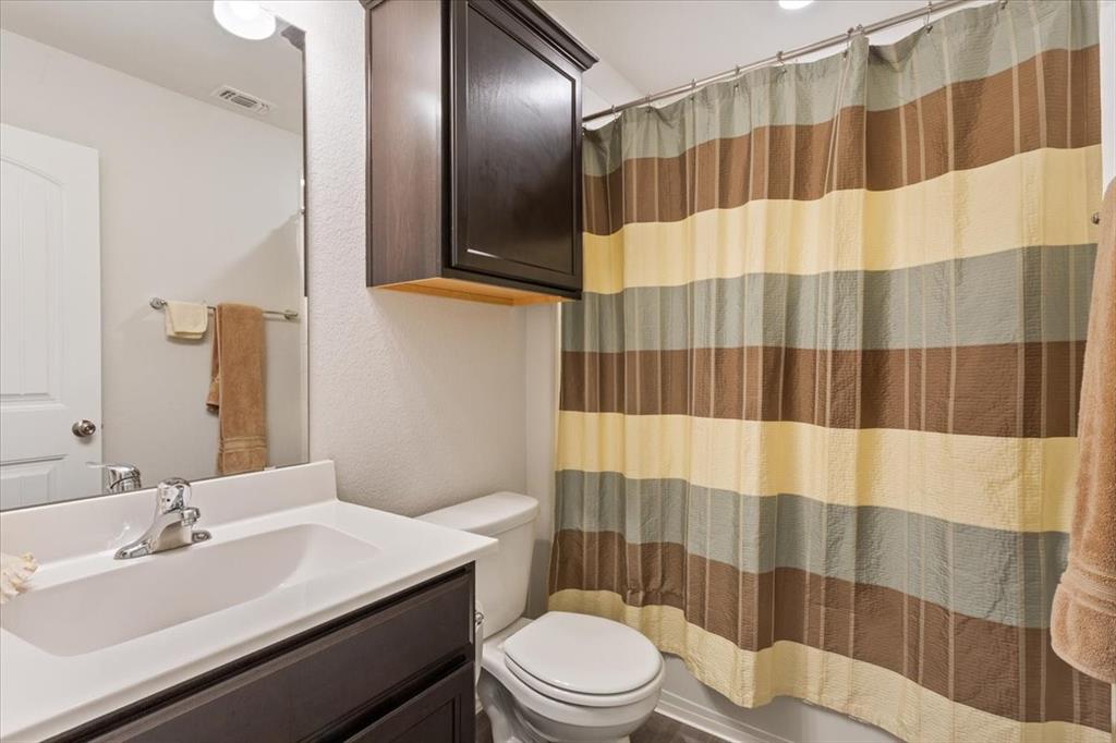 11204 Echo Drive Waco, TX 76708 - Photo 21 of 27 a bathroom with a sink a toilet a shower and a mirror