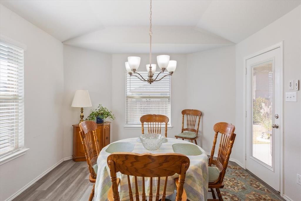 11204 Echo Drive Waco, TX 76708 - Photo 10 of 27 a dining room with furniture a potted plant and wooden floor
