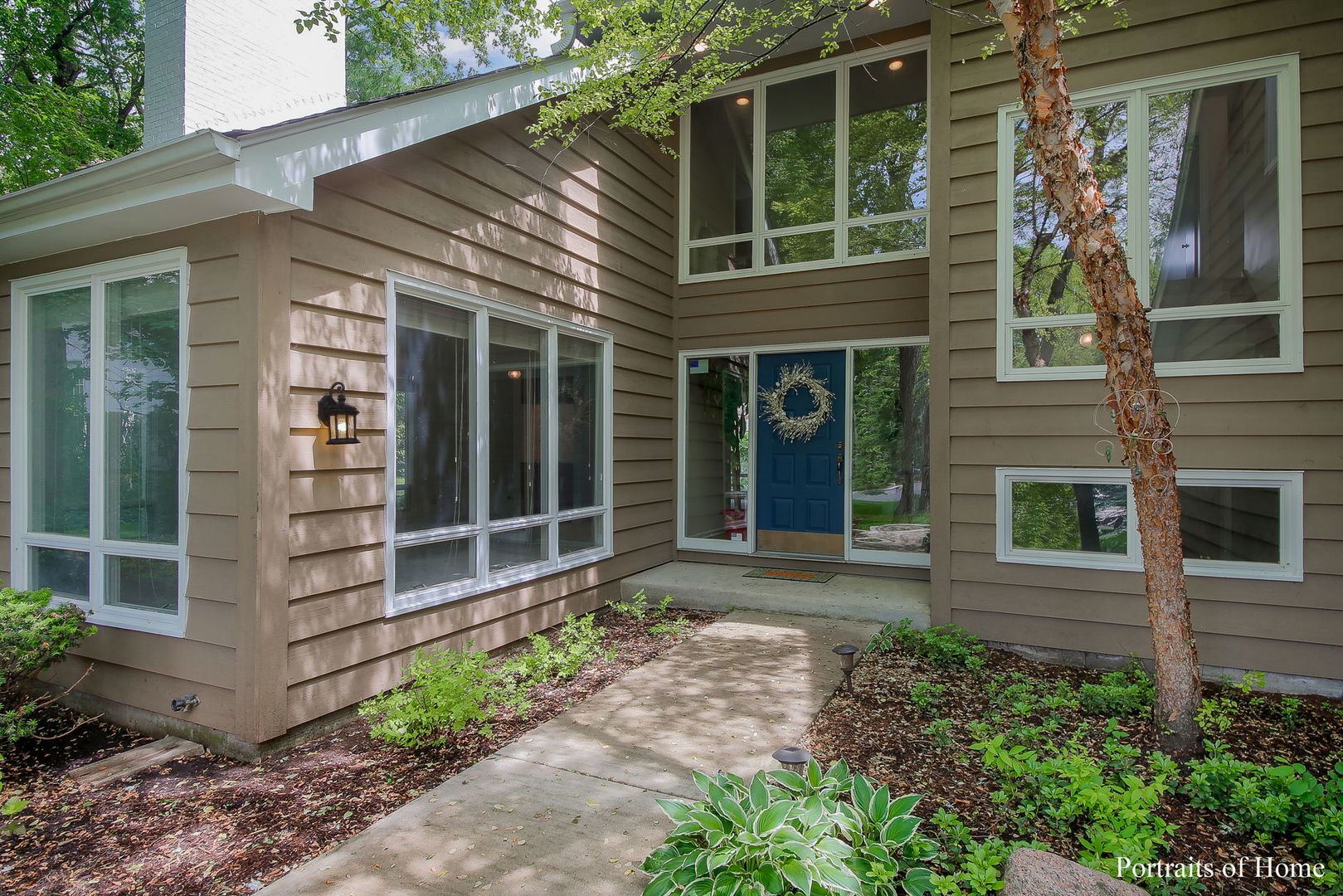 1S781 Carrol Gate Road Wheaton, IL 60189 - Photo 2 of 30 a front view of a house with a yard and potted plants