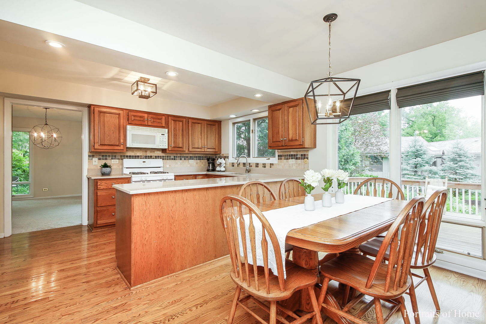 1S781 Carrol Gate Road Wheaton, IL 60189 - Photo 13 of 30 a dining room with stainless steel appliances granite countertop a stove top oven a sink dishwasher a dining table and chairs with wooden floor