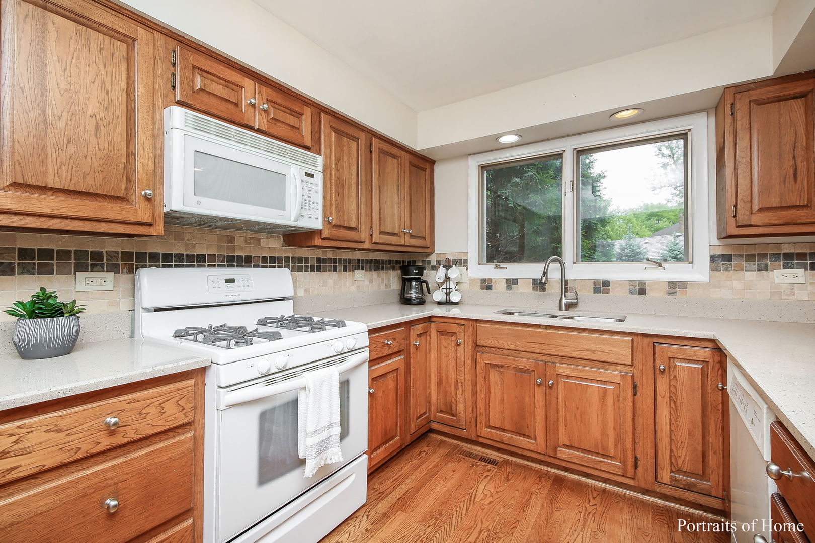 1S781 Carrol Gate Road Wheaton, IL 60189 - Photo 10 of 30 a kitchen with stainless steel appliances granite countertop wooden cabinets a stove a sink and dishwasher with wooden floor