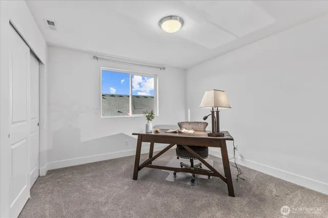 a view of a workspace with furniture