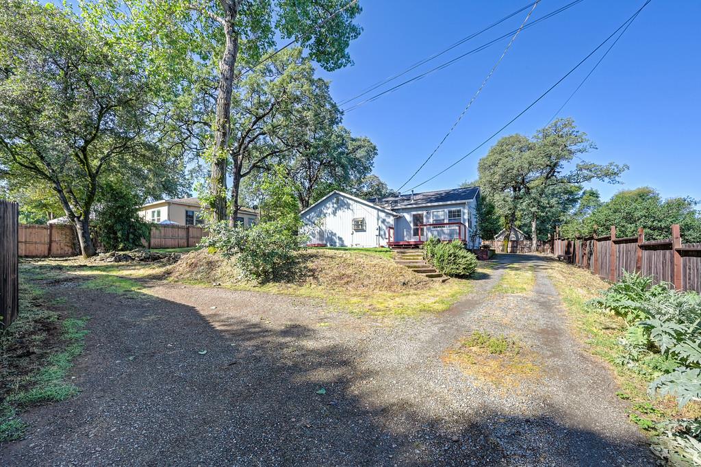 12365 Reba Road Auburn, CA 95603 - Photo 5 of 62 a view of house with outdoor space and trees in the background