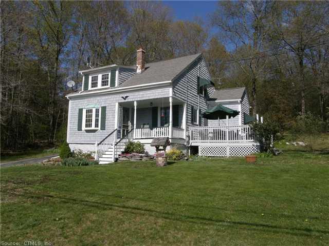 151 Wagher Road Thompson, CT 06255 - Photo 1 of 1 a front view of a house with a garden and trees